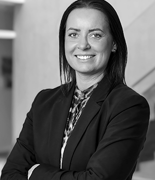 Kvinde i sort blazer på grå baggrund