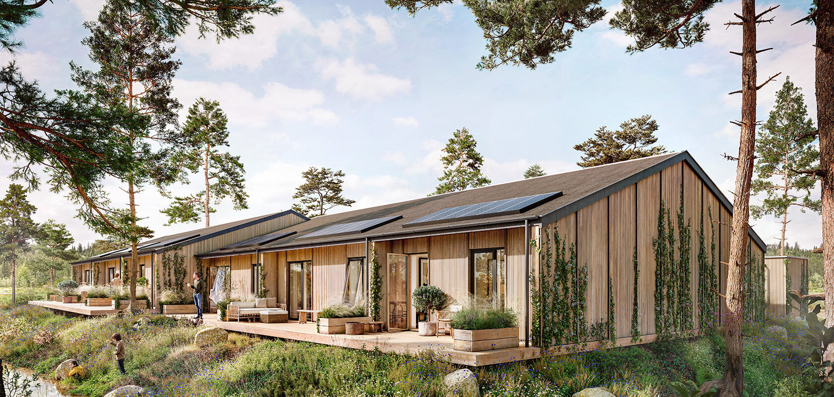Moderne træbygninger i naturskønt område med solpaneler på taget og grønne omgivelser.